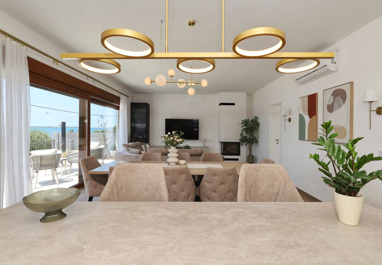 Dining area of Villa Diaria with living area, terrace access and sea view in Vrsi