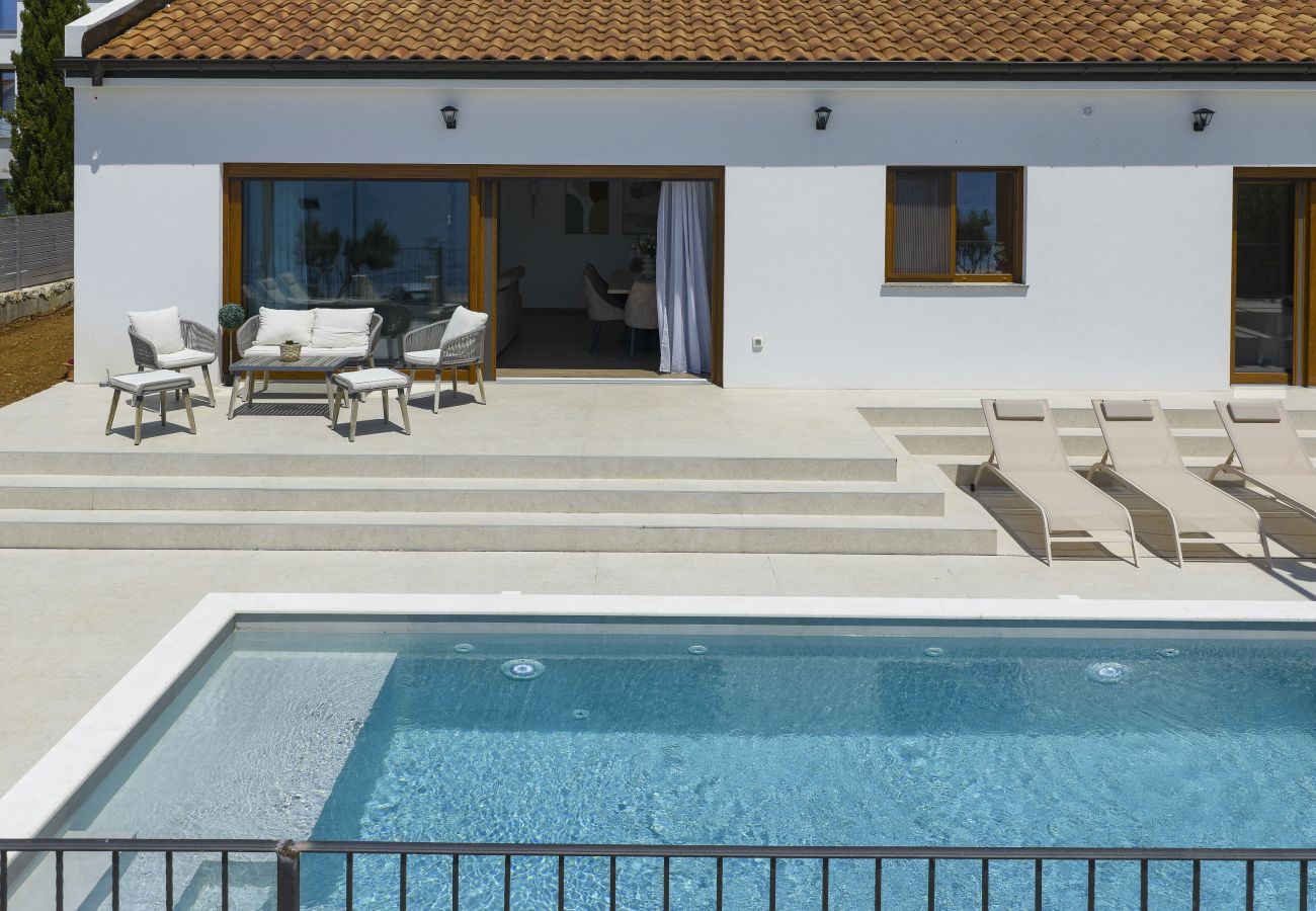 Front view of Villa Diaria with private pool, terrace, sun loungers and lounge area in Vrsi