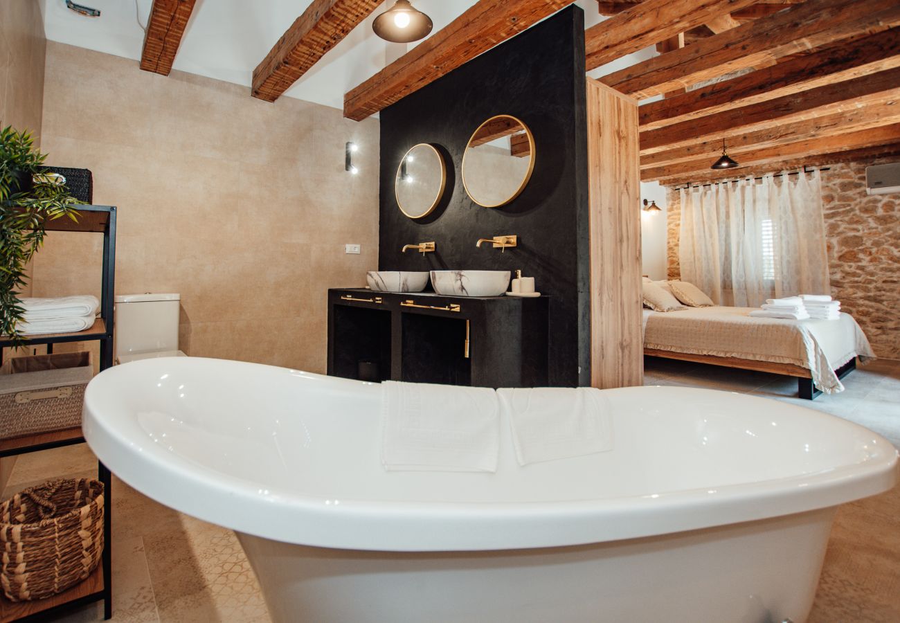 Upper-floor en-suite bathroom with rain shower, bathtub and modern fittings