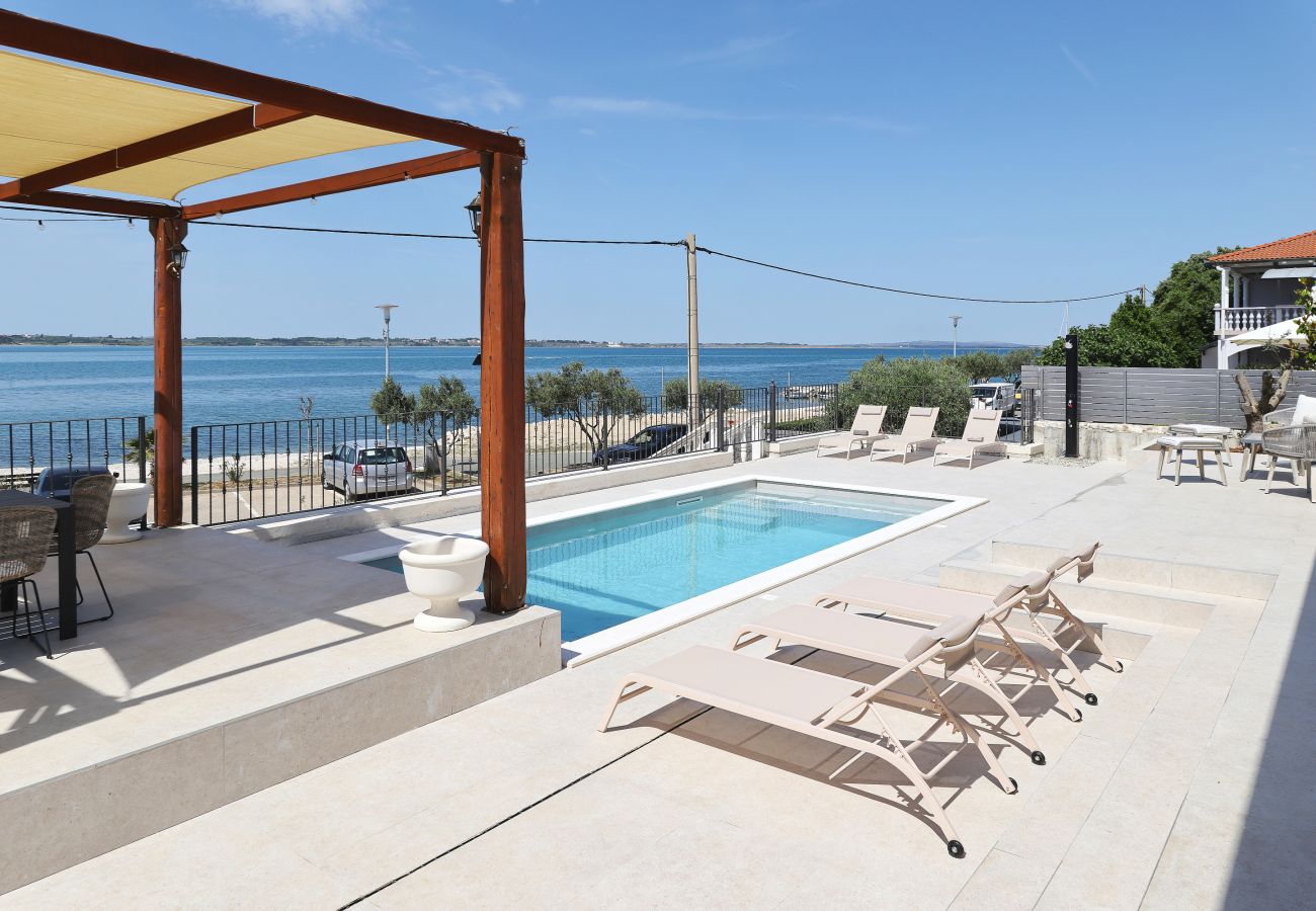 Poolterrasse der Villa Diaria mit Pergola, Sonnenliegen und Meerblick in Vrsi